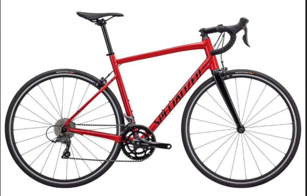 Red Specialized road bike with black fork and drop handlebars